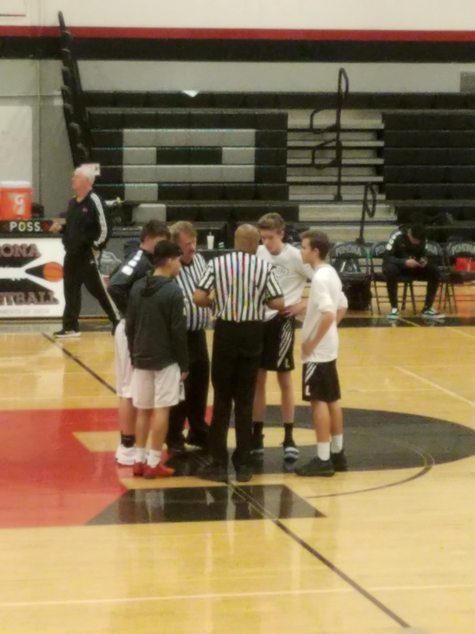 Kyle Wisniewski meeting at center court as a Lakewood JV captain, 2019